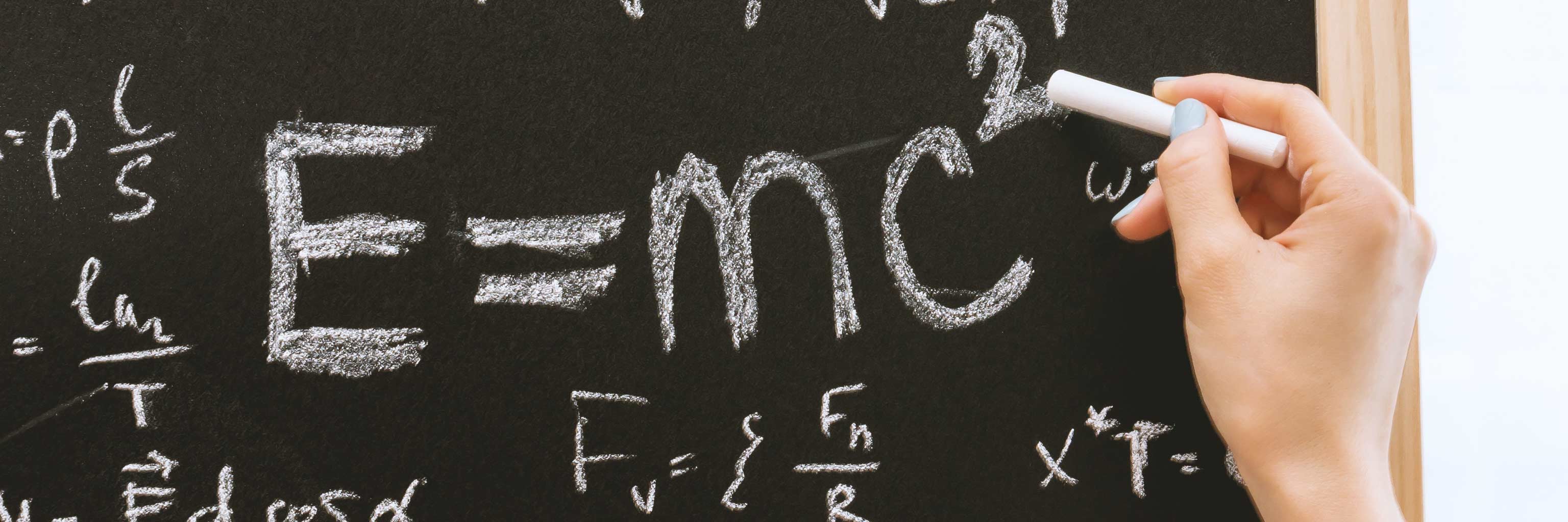 The formula for mass-energy equivalence written on a chalkboard.
